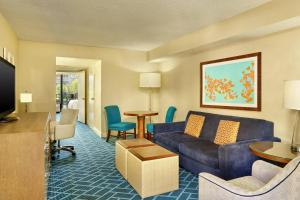 a living room with a couch and a table at Sheraton Orlando Lake Buena Vista Resort in Orlando