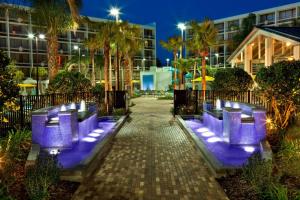 a walkway with purple chairs in front of a building at Sheraton Orlando Lake Buena Vista Resort in Orlando