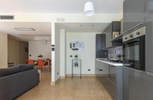 a living room with a couch and a kitchen at relax apartment inn in Catania