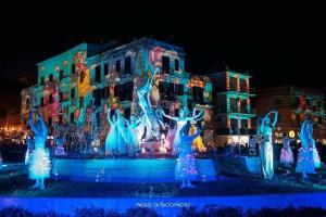 a group ofrozen figurines in front of a building at Mare qui in Gaeta