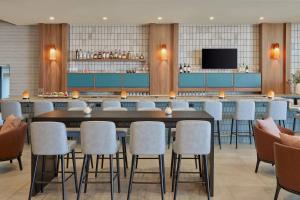 a restaurant with a large table and chairs at Delta Hotels by Marriott Denver Thornton in Westminster