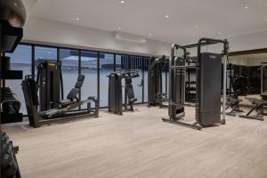 a gym with treadmills and machines in a room at Delta Hotels by Marriott Denver Thornton in Westminster