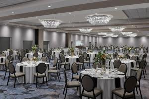 a banquet hall with tables and chairs and chandeliers at Delta Hotels by Marriott Denver Thornton in Westminster