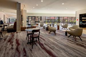 a lobby with couches and tables and chairs at Courtyard by Marriott Oxnard/Ventura in Oxnard