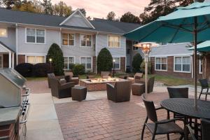 a patio with a fire pit in front of a house at Residence Inn Pinehurst Southern Pines in Southern Pines