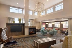 a lobby with a living room with a fireplace at Residence Inn by Marriott Winston-Salem Hanes Mall in Winston-Salem