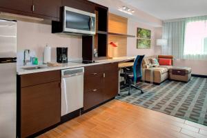 a kitchen with a desk and a living room at TownePlace Suites by Marriott Parkersburg in Parkersburg