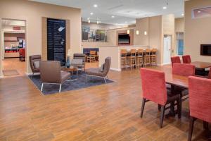 a dining room with a table and chairs at TownePlace Suites by Marriott Parkersburg in Parkersburg