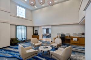 a lobby with chairs and a table in a building at Fairfield Inn and Suites by Marriott Clearwater in Clearwater