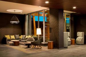 a living room with a couch and chairs at Courtyard by Marriott Prince George in Prince George