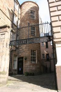 un gran edificio de ladrillo con un cartel. en The Merchant City Inn, en Glasgow