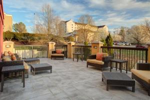 a patio with chairs and tables and a fence at Courtyard Richmond Chester in Chester