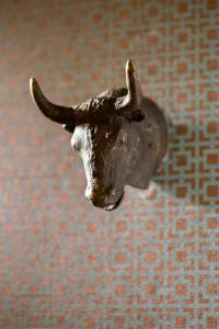 a statue of a bull head on a wall at Hotel ICON, Autograph Collection in Houston