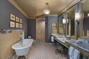 a bathroom with a large tub and two sinks at Hotel ICON, Autograph Collection in Houston