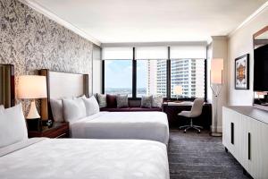 a hotel room with two beds and a desk at JW Marriott New Orleans in New Orleans