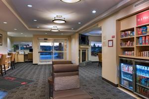 a waiting room at a library with chairs and tables at TownePlace Suites Fayetteville Cross Creek in Fayetteville