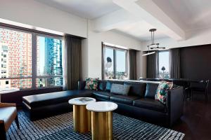 a living room with a couch and a table at New York Marriott at the Brooklyn Bridge in Brooklyn