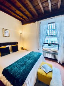 a bedroom with a large bed and a window at La Mandorla studio apartment in Piazza del Duomo in Florence