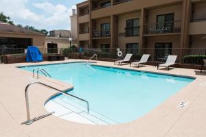 a large swimming pool in front of a building at Courtyard Montgomery in Montgomery