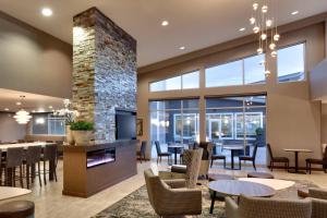 a restaurant with tables and chairs and a fireplace at Residence Inn by Marriott Salt Lake City-West Jordan in West Jordan