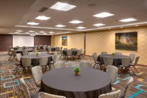 a room with tables and chairs in a room at Residence Inn by Marriott Salt Lake City-West Jordan in West Jordan