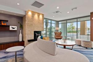 a living room with a couch and a table at Fairfield Inn & Suites by Marriott St Petersburg North in St. Petersburg