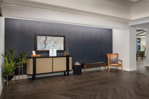 a lobby with a black wall and a table and chairs at Courtyard by Marriott Savannah Downtown - Historic District in Savannah