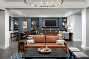 a living room with a couch and a table at Courtyard by Marriott Savannah Downtown - Historic District in Savannah