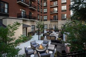 an apartment patio with furniture and a fire pit at Courtyard by Marriott Savannah Downtown - Historic District in Savannah