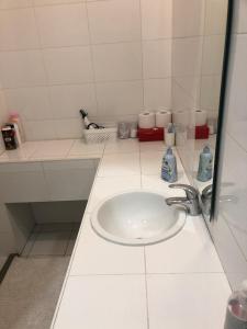a white bathroom with a sink and a mirror at INDUSTRIAL STUDIO 1 in Ljubljana +4 photos