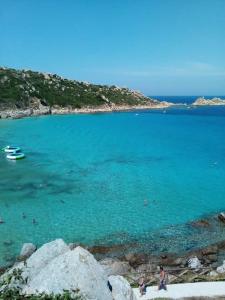 a group of people swimming in a body of water at La dolce dimora in Olbia