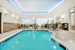 a pool with blue water in a building with windows at Fairfield Inn & Suites by Marriott Van in Van