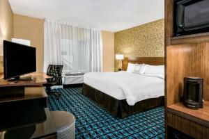 a hotel room with a bed and a flat screen tv at Fairfield Inn & Suites by Marriott Van in Van