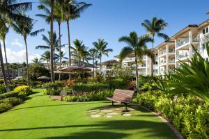 a park with a bench in front of a building at Marriott's Kauai Lagoons - Kalanipu'u in Lihue