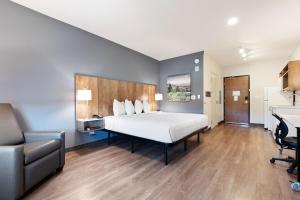 a bedroom with a bed and a desk and a chair at Extended Stay America Suites - Atlanta - McDonough in McDonough