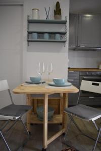 a kitchen with a wooden table and two chairs at Casa Playita de Luz in Barbate
