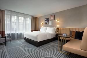 a hotel room with a bed and a couch at Neues Schloss Privat Hotel Zurich, Autograph Collection in Zurich