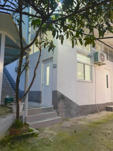 una casa con un árbol delante en Guest House Dashi, en Gjirokastra 7 fotos más