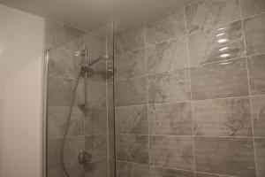 a bathroom with a shower with a glass door at 3 Bedroom Full Property in Cramlington