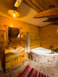 a bathroom with a large tub and a sink at Old Wine House - Montenegro in Herceg-Novi