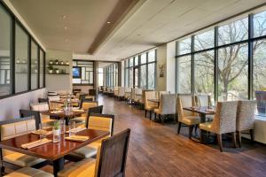 a restaurant with tables and chairs and windows at Salt Lake City Marriott University Park in Salt Lake City