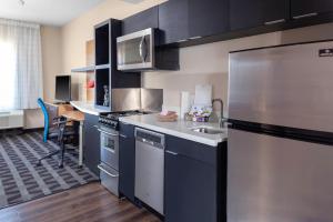 a kitchen with a stainless steel refrigerator and a sink at TownePlace Suites by Marriott San Antonio Westover Hills in San Antonio