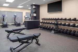 a fitness room with exercise equipment and a flat screen tv at TownePlace Suites by Marriott San Antonio Westover Hills in San Antonio