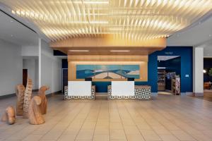 a lobby with a waiting area with chairs and a ceiling at SpringHill Suites by Marriott San Diego Oceanside/Downtown in Oceanside