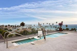 a swimming pool on a balcony with a view of the ocean at SpringHill Suites by Marriott San Diego Oceanside/Downtown in Oceanside