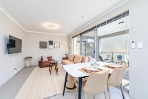 een keuken en een woonkamer met een tafel en stoelen bij Swan Valley Serviced Apartments in Middle Swan