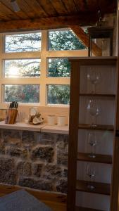 two wine glasses on a shelf in front of a window at Old Wine House - Montenegro in Herceg-Novi