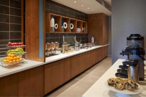 a buffet line in a hotel with a plate of food at SpringHill Suites by Marriott Fort Myers Estero in Estero