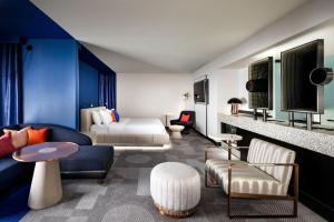 a living room with a couch and a bed at W Toronto in Toronto