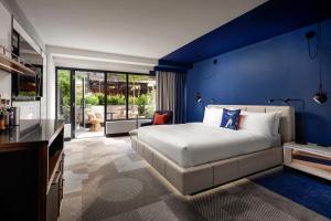 a bedroom with a bed and a blue wall at W Toronto in Toronto
